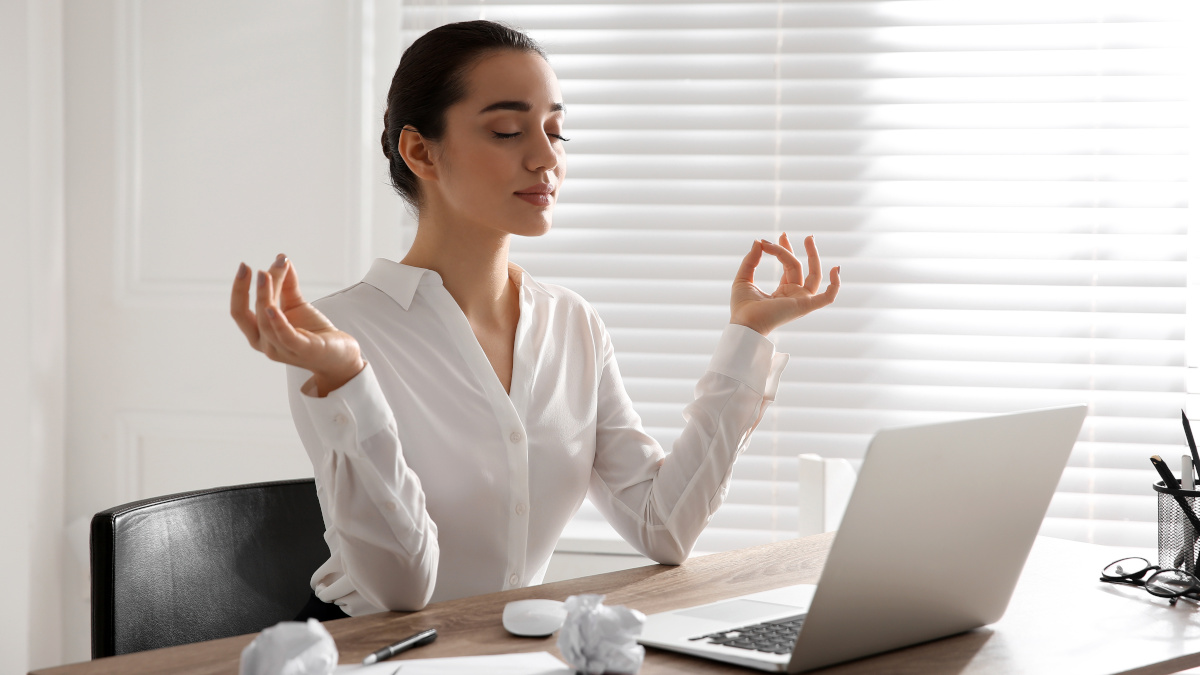 Calm woman in the office dealing with stress Woman taking anti-stress supplements
