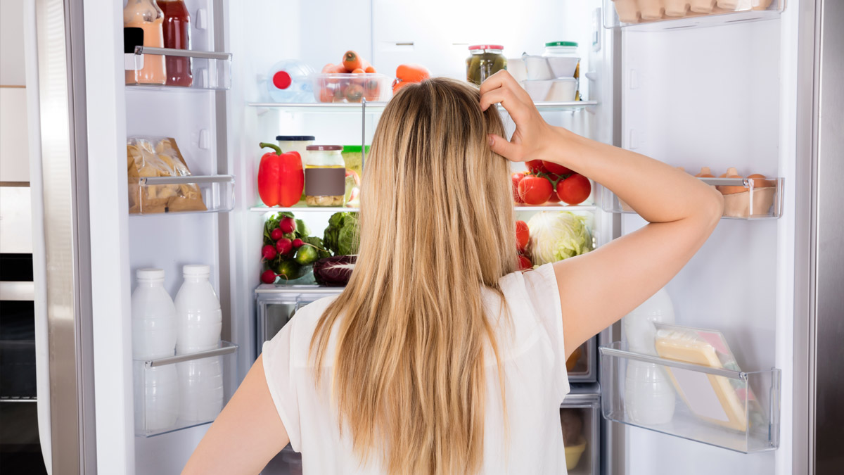 Photo of someone looking for something in the fridge