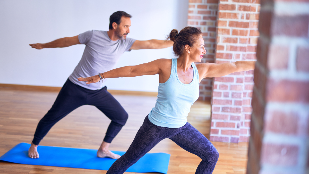 A couple exercising on blue mats